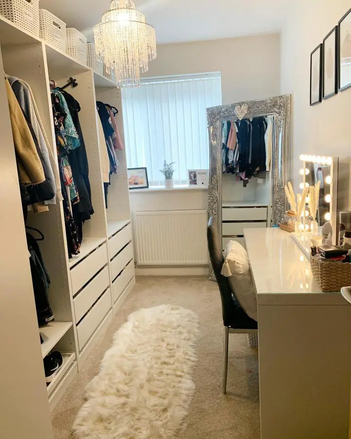 Glamorous white dressing room from @a_home_filled_with_love featuring dramatic crystal chandelier and built-in storage solutions.