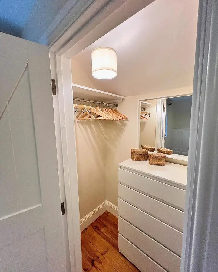 White drum pendant light closet from @limeandlintel showcasing small dressing room ideas with built-in storage.
