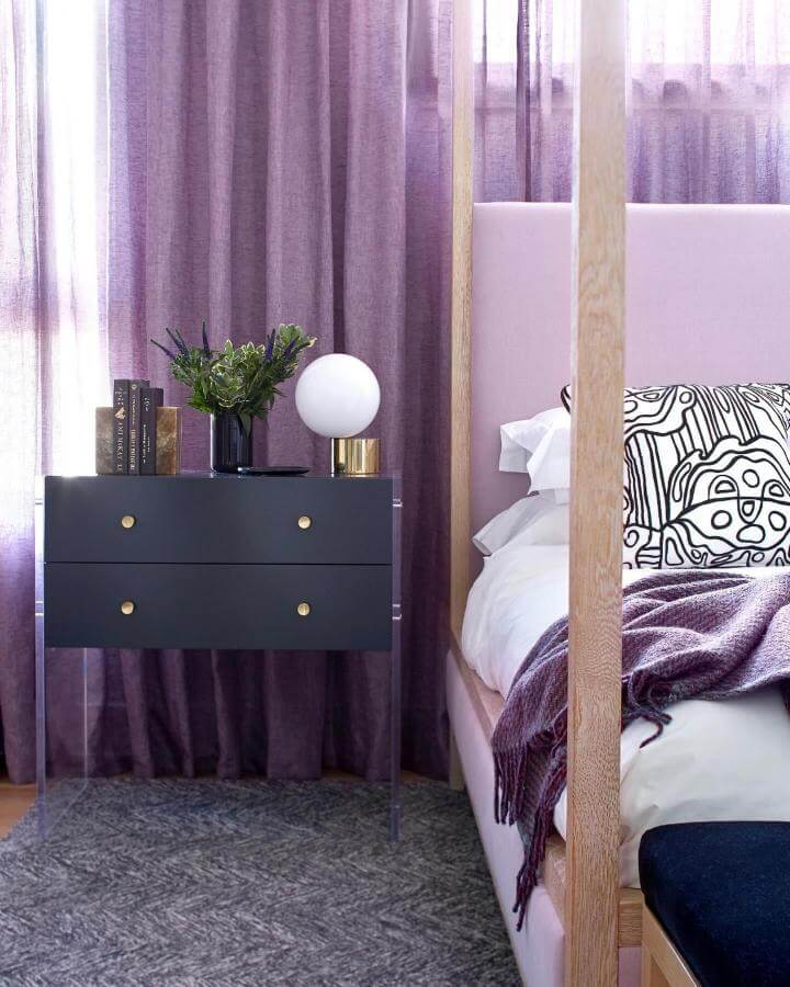 Soft lavender layered curtains and cozy bed frame in warm wood tones from @cynthiafergusondesigns with modern accent pieces.