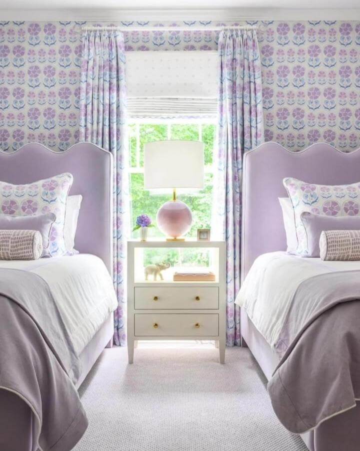 Soft lavender velvet beds and floral patterned curtains from @definedesignonline create a cozy, elegant bedroom vibe.