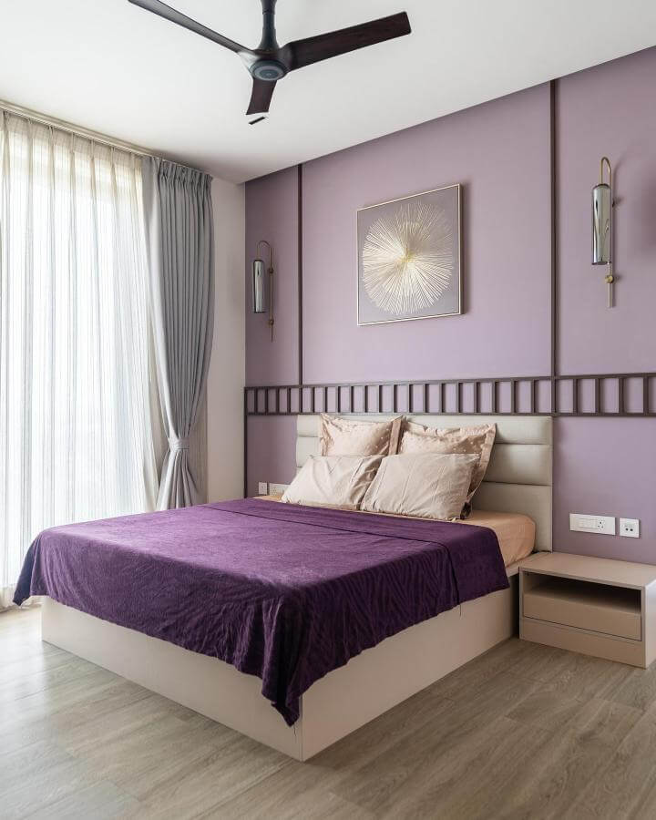 Soft lavender painted bedroom walls with plush bedding and beige leather headboard from @roaisharchitecture showing modern cozy style.