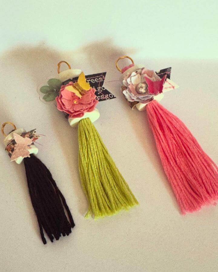 Three colorful thread tassels with paper flowers and butterflies by @mrs_s_snailmail for spring crafts for adults. Bright and playful charm accents.