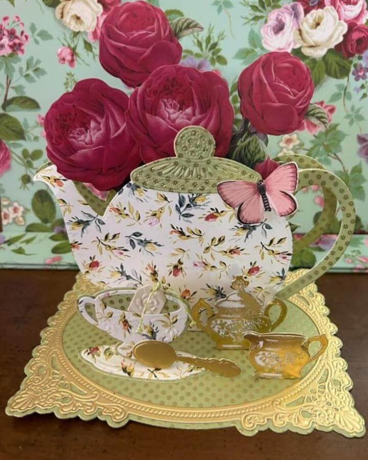 Gold and pastel floral paper teapot centerpiece with pink paper flowers and butterfly detail from @annagriffininc. Spring crafts for adults inspiration.