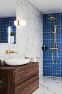 Sophisticated marble and navy elements in a bathroom from @grohe_uk, perfect for creating a luxurious haven.