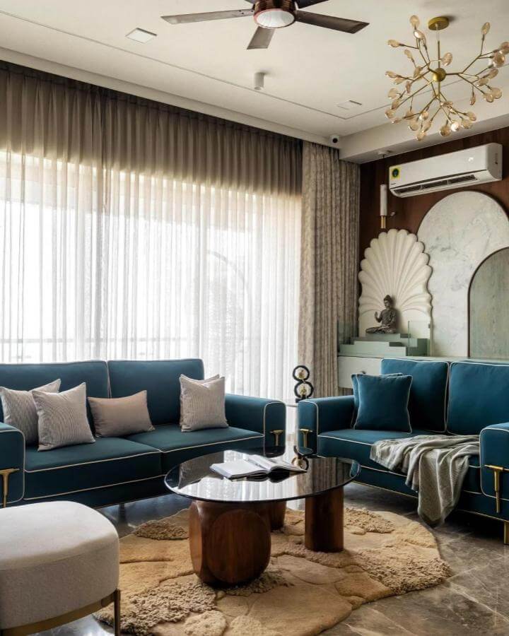 Teal velvet sofas in a cozy living room with wooden table and layered rugs by @thestyle.bureau show elegant teal living room ideas.
