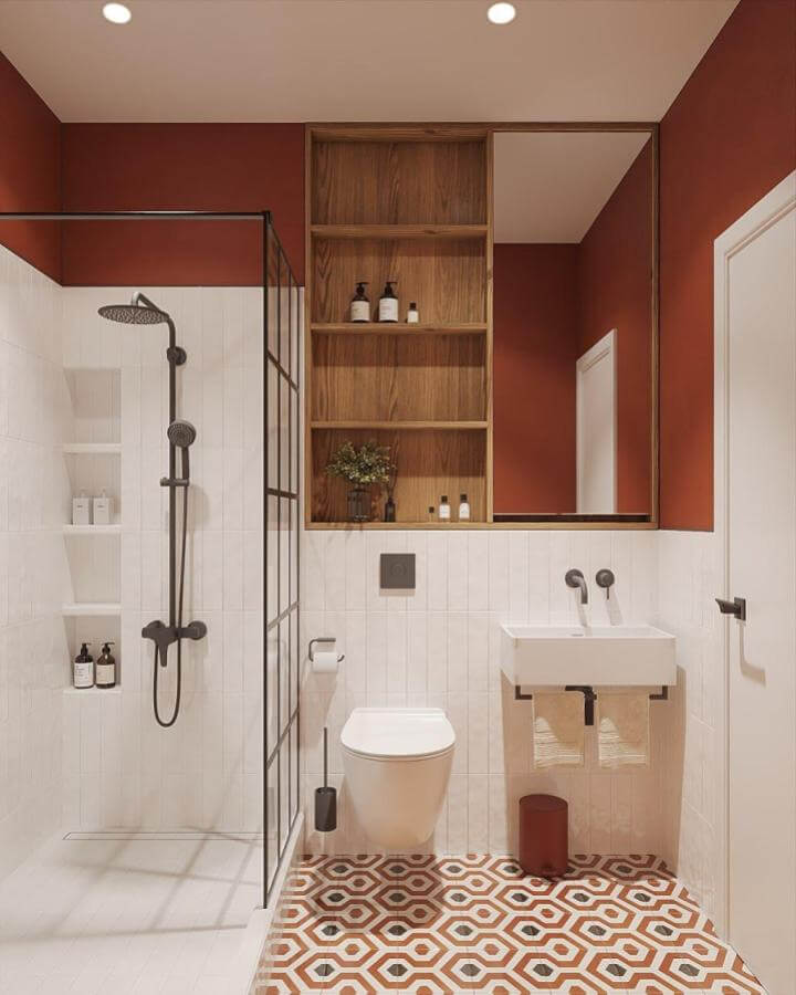 Warm terracotta walls with geometric tiled floor and natural wood shelving by @surzh_design in a modern bathroom space with black fixtures and white accents.