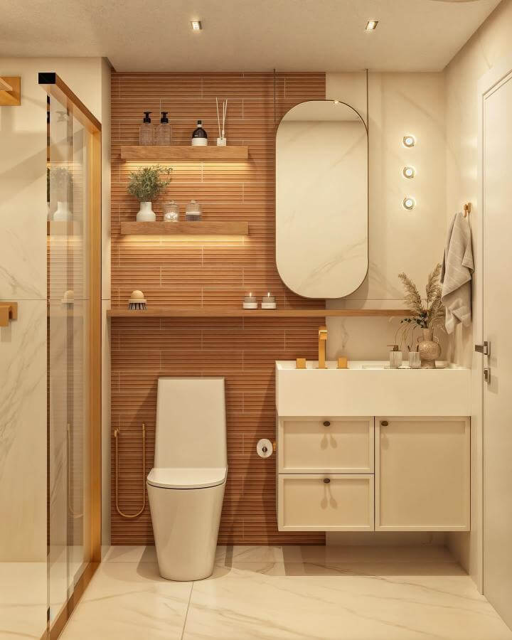 Terracotta tile accent wall with wooden shelves and cream cabinetry in warm minimalist bathroom by @jaquelineandrade.arq with natural textures and cozy lighting