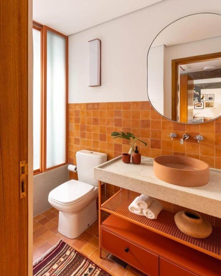 Terracotta tiled bathroom with matching basin and natural textures by Future Studio warm earthy tones and cozy design elements.