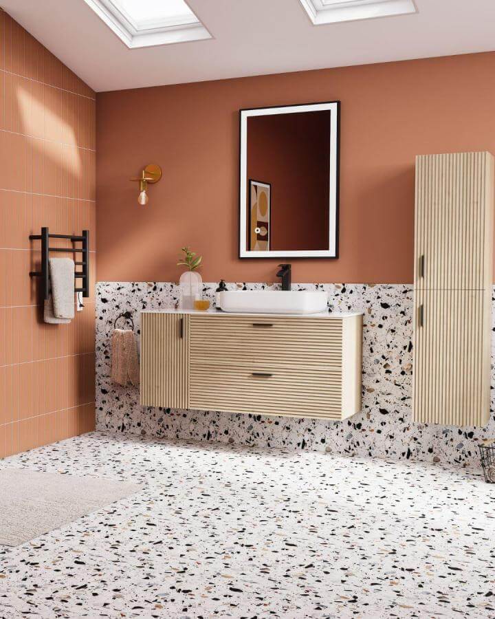 Terracotta walls with terrazzo floors modern bathroom design from @bathdepot showing warm terracotta bathroom ideas with wood and black accents
