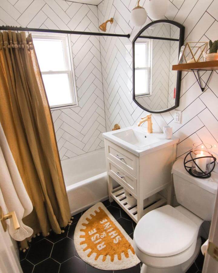 White herringbone tiles and gold fixtures in a compact bathroom from @prettyprospectcottage brighten a small living space.