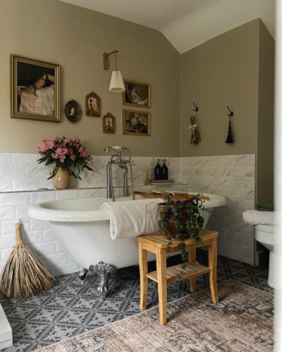 Clawfoot bathtub with silver legs, olive walls, subway tiles, patterned floor, and vintage portraits by @ourvictorianhome1875 Victorian bathroom ideas.