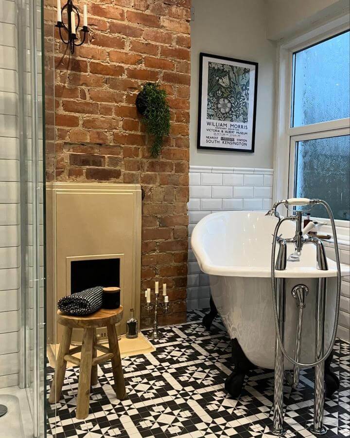 Black and white patterned tile floor, clawfoot tub, exposed brick wall in Victorian bathroom ideas from @elmhurst57. Classic meets rustic with vintage accents.