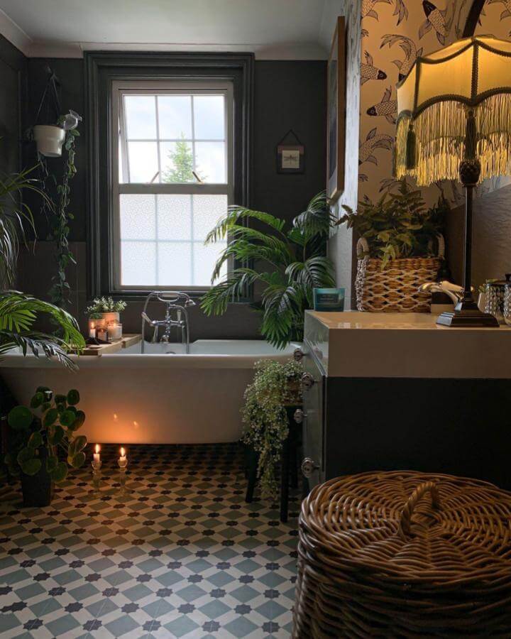 Dark green walls and clawfoot tub with patterned tile floor and wicker basket from @stove_pipe_house Victorian bathroom ideas ambiance.