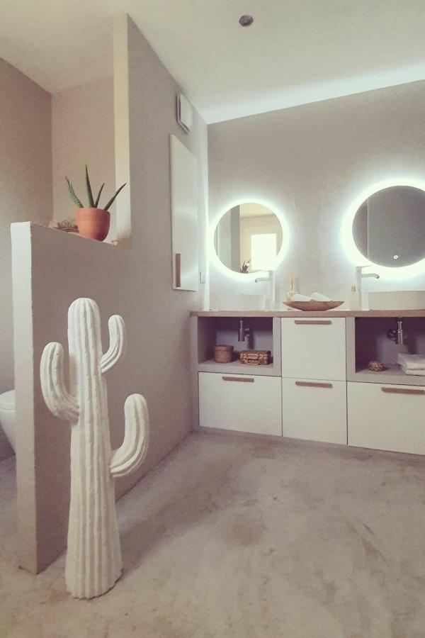Terracotta bathroom with floating vanities showcasing wabi sabi bathroom ideas through warm earth tones and minimalist design.