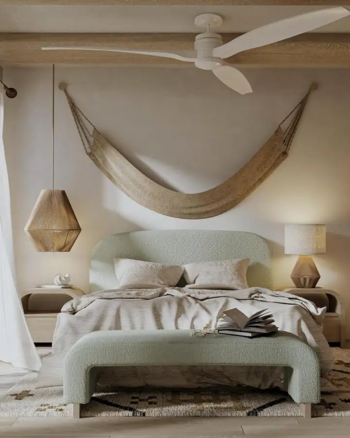 Sage green upholstered bed with suspended jute hammock from @pacific_oaks. Natural textures and earthy tones create calming retreat.