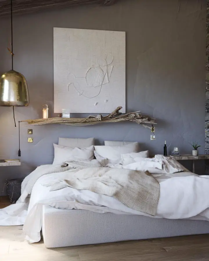 Weathered driftwood shelf bedroom displaying natural textures perfect for wabi sabi bedroom ideas. Organic wood piece mounted above neutral bedding.