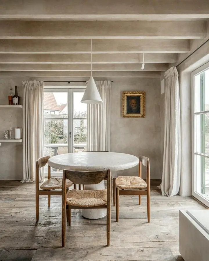 Weathered stone dining table from @imagicasa.be. Natural patina and worn surfaces showcase imperfect beauty perfectly.