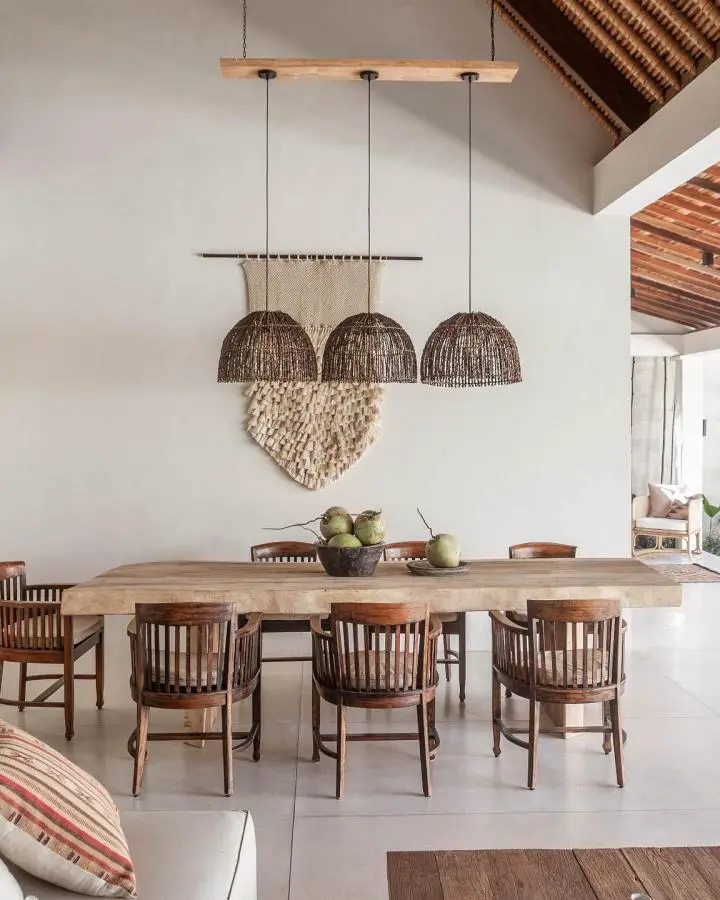 Natural woven pendant lights from @villamassilia. Rustic dining room featuring organic textures and handcrafted elements.