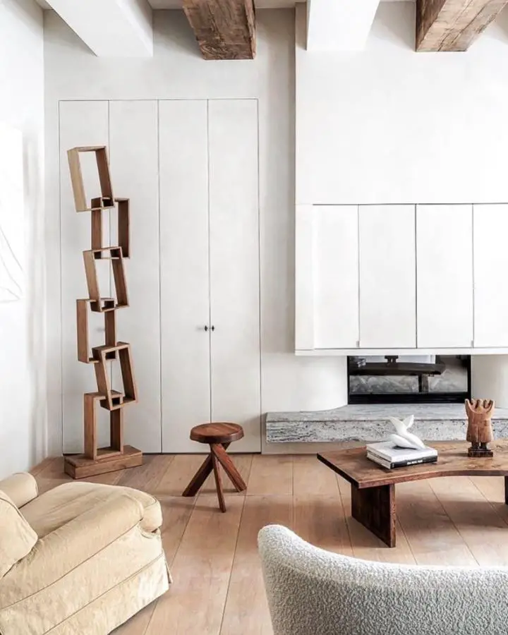 Asymmetrical wooden bookshelf display from @royceflight. Natural wood against white minimalist storage creates organic contrast.