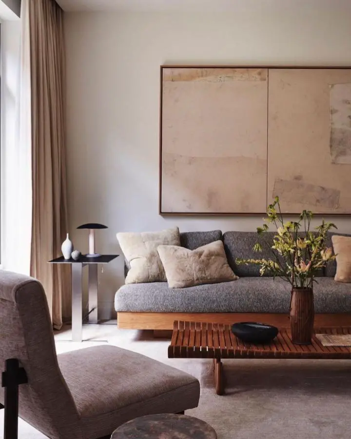 Weathered wood artwork display from @just_my_design_taste. Natural grain patterns create organic wall art above gray sofa.