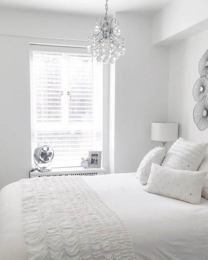 White textured bedding and soft accents in peaceful bedroom from @ourgreynest featuring delicate ruffles and elegant lighting.