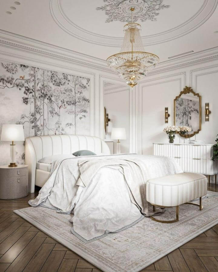 White plush curved bed and soft bedding from @natalydays with classic molding and golden accents in a bright elegant bedroom.