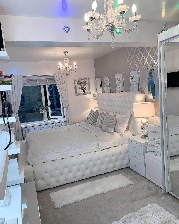 White tufted bed frame and soft furnishings in a white aesthetic bedroom ideas setting from @herzenstimme. Elegant, cozy, and textured.