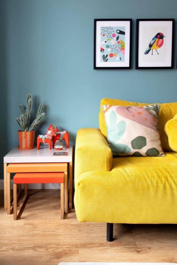 Vibrant accents enhance a modern yellow sofa from @fromcity2suburb, infusing charm into a stylish living space.